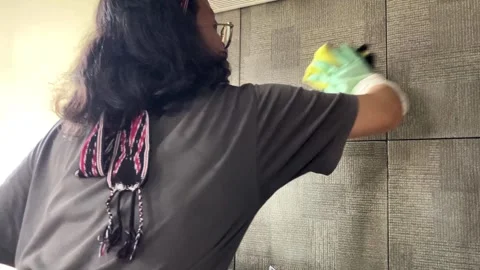 Slow mo selective focus of housewife cleaning kitchen wall tile. Stock Footage 345043728