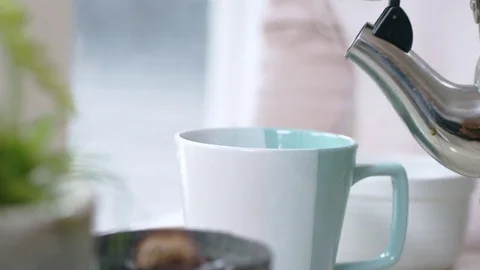 Slow-mo shot of boiling water shooting out of tea kettle Stock Footage 84477654