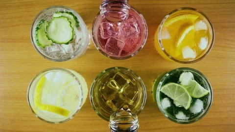 Slow mo. Six different drinks in two glasses to pour a drink top view Stock Footage 76767429