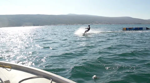 Slow-Mo: Skilled Wakeboarder Carving And Doing 360 Front Flip Stock Footage 36991462
