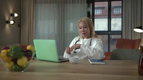 Slow-mo: Slow-mo: Young Southeast Asian Doctor Giving Online Advice via Stock Footage 136364144