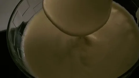 Slow mo. Spread the batter into a frying pan Stock Footage 75378969