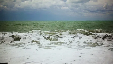 Slow mo in a troubled sea, the wave curls about the shore Stock Footage 82123927