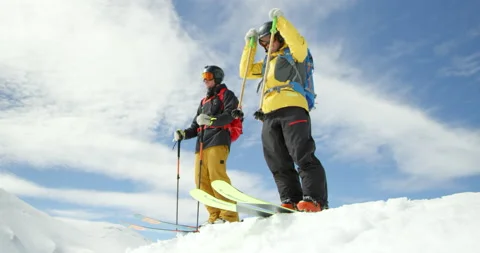 Slow Mo Of Two People Going Down Steep Snowy Hill Stock Footage 139469679