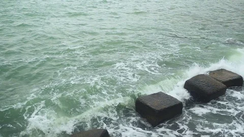 Slow mo the wave breaks against the breakwater stones Stock Footage 81969181