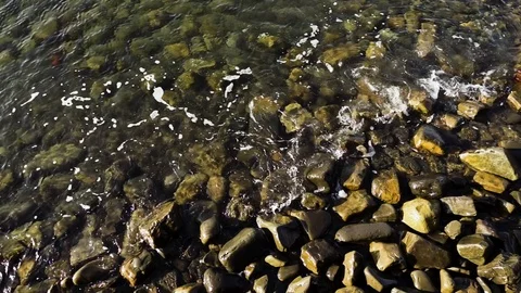 Slow Mo wave rolls to shore Stock Footage 82384674
