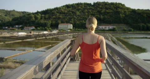 Slow Mo Of Woman Running Between Salt Lakes Stock Footage 141649931