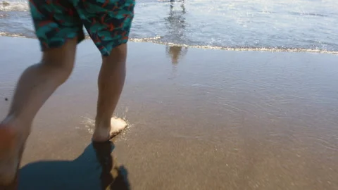 Slow Mo | Young Boy Jumping Into the Water on the Beach Stock Footage 137763106