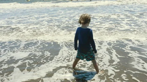 Slow-Mo | Young Boy Standing on Beach Stares Into Ocean Stock Footage 137763220