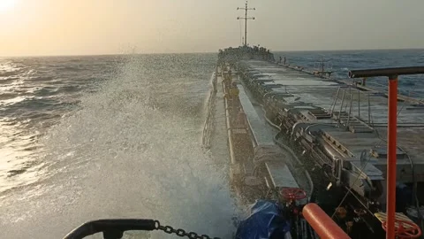 Slow motion 0.5x of stormy ocean wave crashing against OBO carrier in 4K Stock Footage 346609706