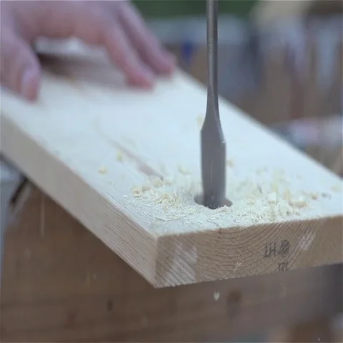 Slow Motion 1 inch drill bit drilling through wooden board Video stock 69540608