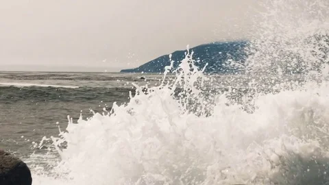 Slow motion (100fps) pacific ocean waves crashing into rocks Stock Footage 78661138