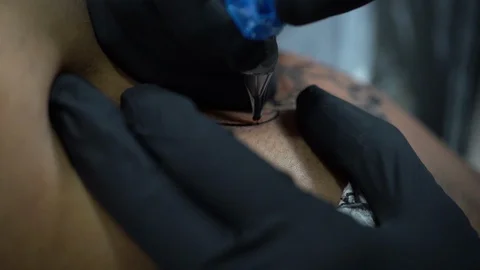Slow motion (100fps) shot of tattoo machine working Stock Footage 112878221