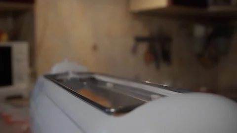 Slow motion 120 fps, fried bread popping out of a toaster. Closeup. Move camera Stock Footage 119539860