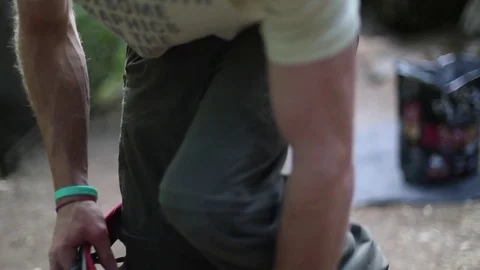 Slow motion at 120 fps rock climber putting on his harness to climb or belay Video stock 72473810