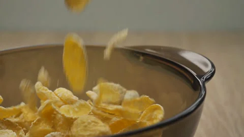Slow motion 180 fps, close-up of cornflakes falling into a glass, transparent Video stock 150403998