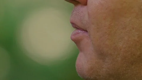 Slow motion 180fps: Vaping Man blows smoke in closeup while talking Stock Footage 91705830