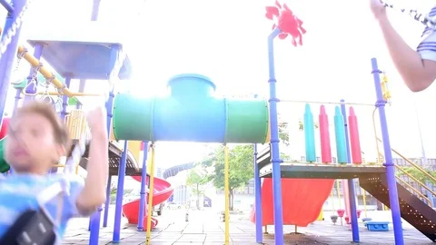 Slow motion 2 boy play swing Stock Footage 81028242