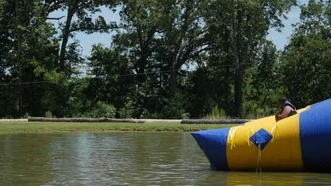 Slow-motion of 3 teens jumping into lake Video stock 118724418