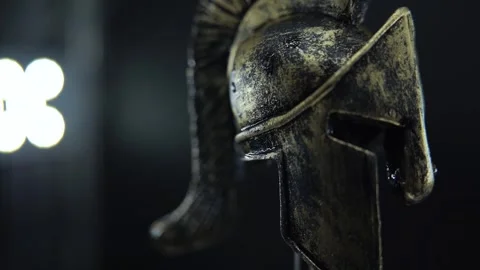 Slow motion 360 spin of wet gladiator helmet, bronze warrior armor cinematic Stock Footage 334137315