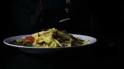 Slow motion 480fps cheese falls to the pasta with bacon and tomatoes Stock Footage 72433132