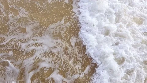 Slow motion 4k 60fps clip of sea waves on shallow sandy water from above. Stock Footage 171447716