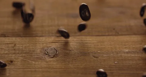 Slow Motion 4K Of Delicious Coffee Beans Falling On To Rustic Wooden Table Stock Footage 113386217