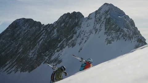 Slow Motion 4K: Hiking up a mountain with Ski on shoulder Freeride Stock Footage 101017794
