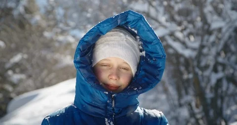 Slow motion, 4K. A lot of snow falls on a teenage girl. The girl in the blue Stock Footage 103120317