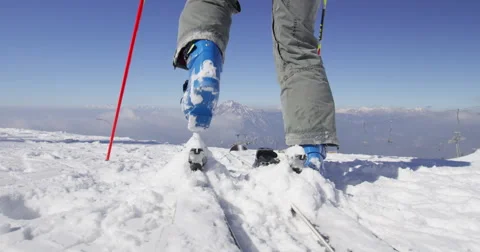 Slow Motion 4K Rear Shot Of Skier Attaching Ski Boots And Setting Off To Skiing Stock Footage 47087077
