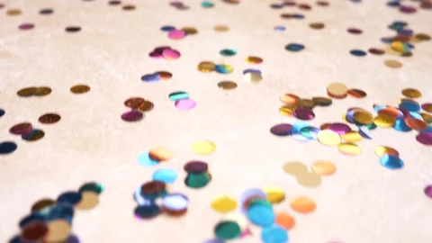 Slow motion. 4k. round multicolored confetti lie on the tiled floor. dolly Видео 88699477