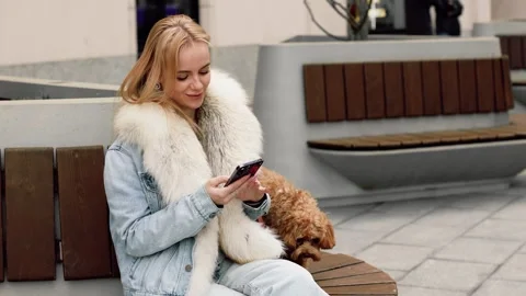 Slow motion 4k shot of a beautiful blonde woman checking her smartphone and p 스톡 동영상 334862901