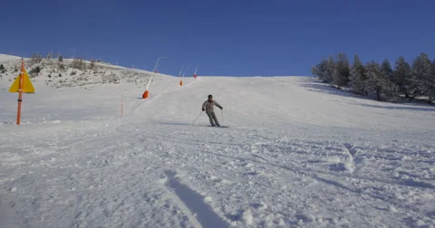 Slow Motion 4K Of Skier Carving Down Wide Slope And Passing Close To Camera Stock Footage 47520052