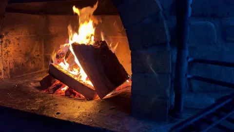 Slow motion 4K video of burning dry woods in the brick outdoor country house man Stock-Footage 233973559