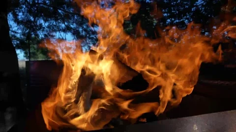 Slow motion 4k Video of a camp fire being oxygenated and thrusting flames, stunn Stock Footage 241750658