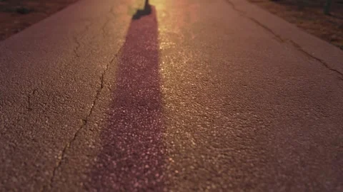 Slow motion 4K video with depth of field focus on asphalt. Riding scooter with Stock Footage 241096219