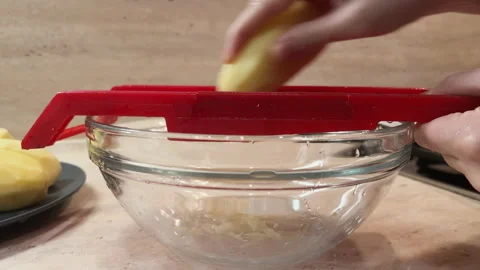 Slow motion 4k video grating potato on plastic shredder. Hands cookinghash Stock-Footage 260244967