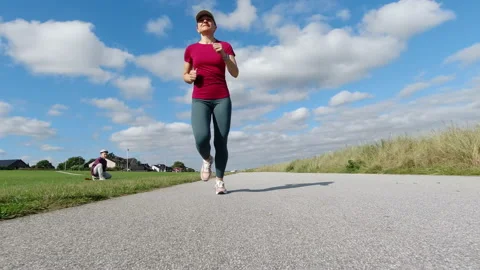 Slow motion 4K video of running beautiful sporty woman motivete a passers by Stock Footage 160354749