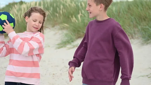 Slow motion 4K video of walking children on wooden pathway at white beach in Stock Footage 201823729