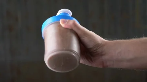 Slow motion. 4k. Young man making a protein shake at home. anonymously Stock Footage 82915135