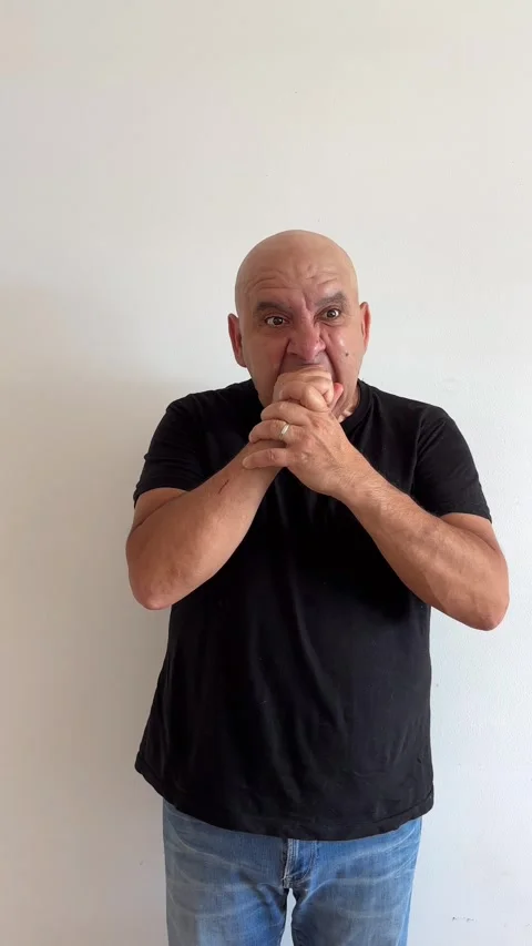 Slow motion of 50 year old Latino man biting fist in anger Stock Footage 337428507
