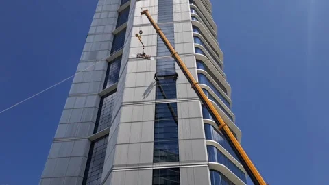 Slow Motion 500 Ton Crane Hoisting 400kg Glass to Waiting Climbers Stock Footage 332902622