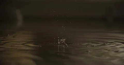 Slow motion 60fps of  water drops in a fountain by night, macro Stock Footage 128766538