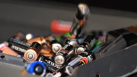 Slow motion aa and aaa batterys being recycled Stock Footage 100819568