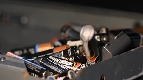 Slow motion aa and aaa batterys being recycled Stock Footage 100819613