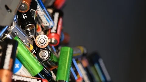 Slow motion aa and aaa batterys being recycled Stock Footage 100820264