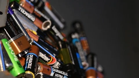Slow motion aa and aaa batterys being recycled Stock Footage 100820347