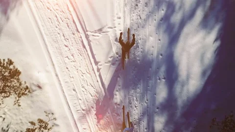 Slow motion. Above angle of mature couple skiing in the forest in winter time Video stock 80199622