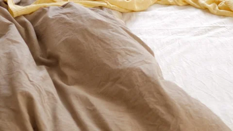 Slow motion above bed with scattered bright clothes Video stock 100366462