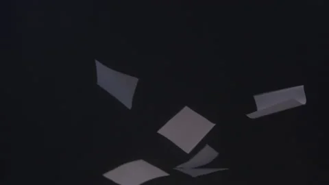 Slow Motion Abstract of Documents Falling Upward Through the Darkness Video stock 210220864